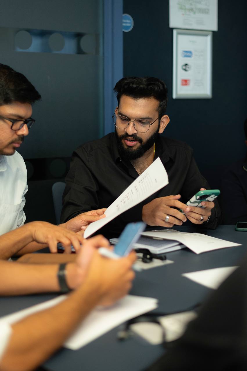 Members reviewing a document together at a monthly meetup