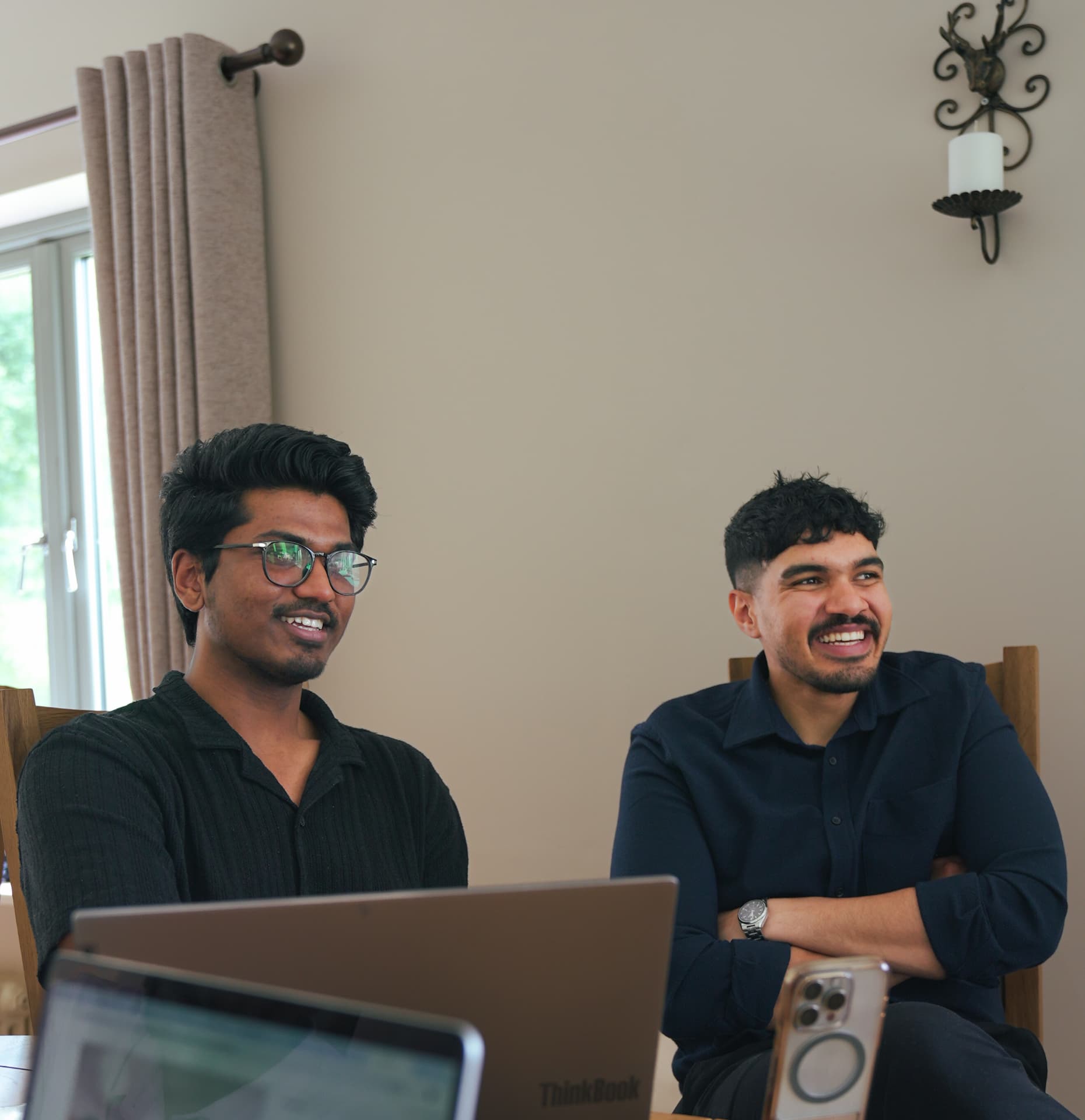 Two members sharing a light moment during a meetup session