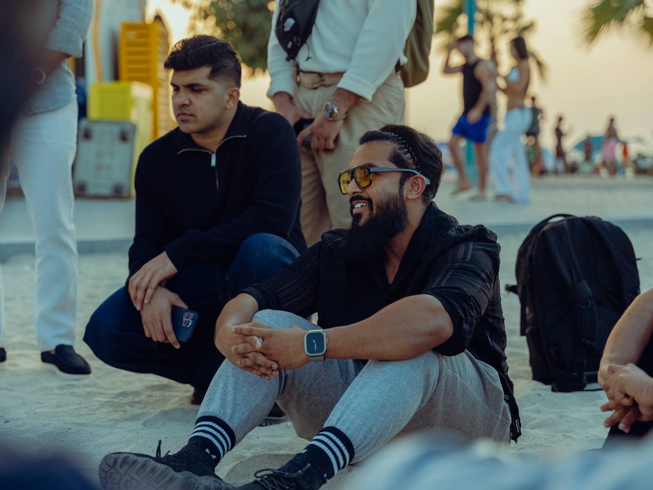 Two members deep in conversation on the beach during a community day out