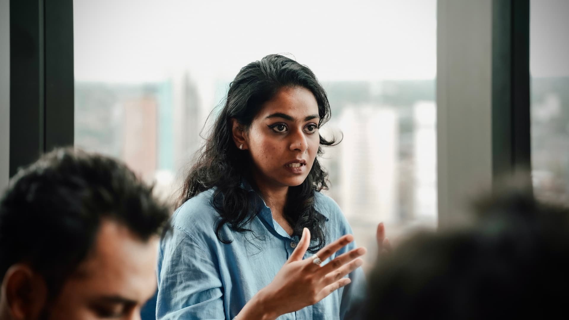 A member leading a discussion by the window at a meetup