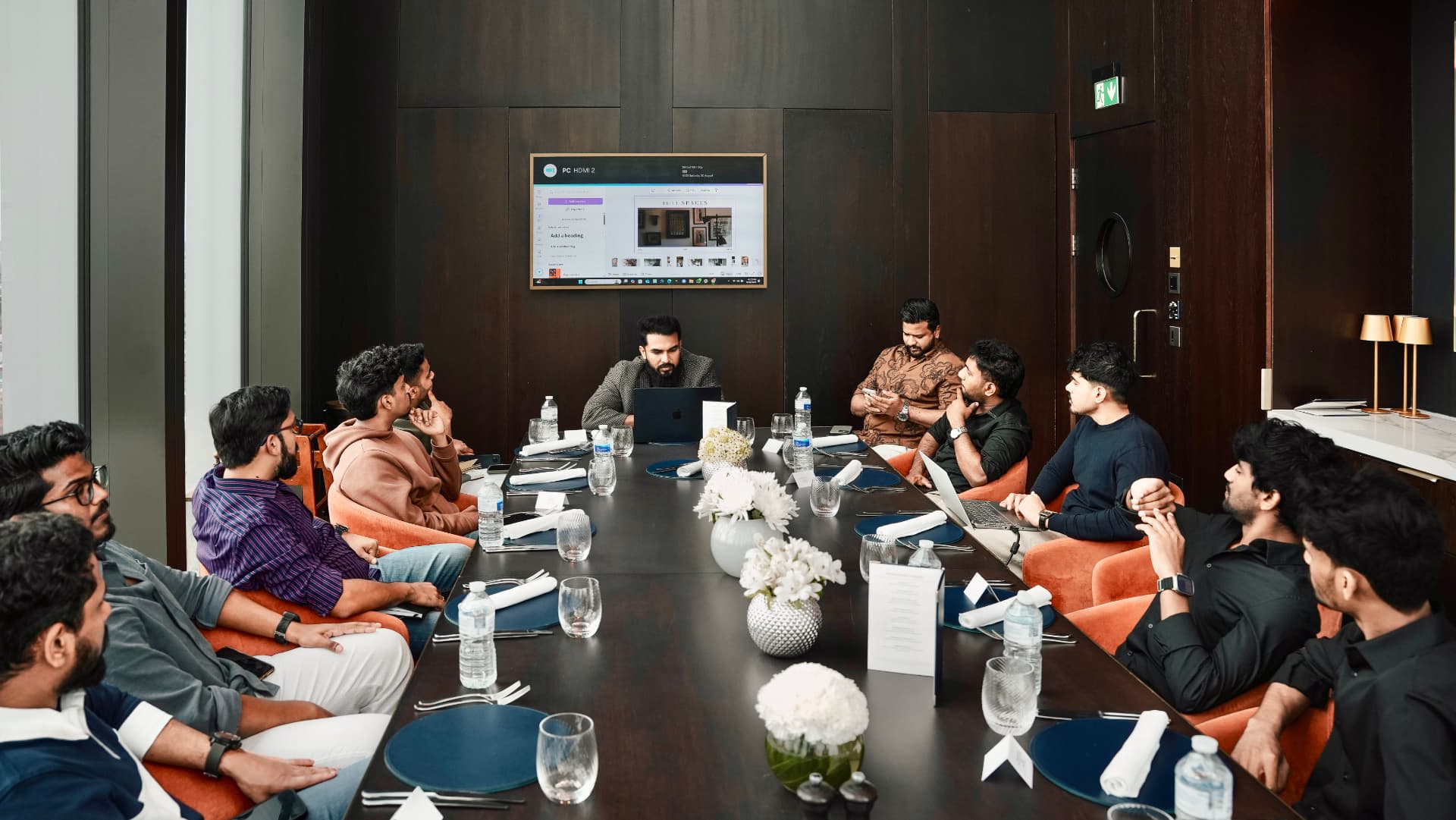 The group around the table during a presentation at a meetup
