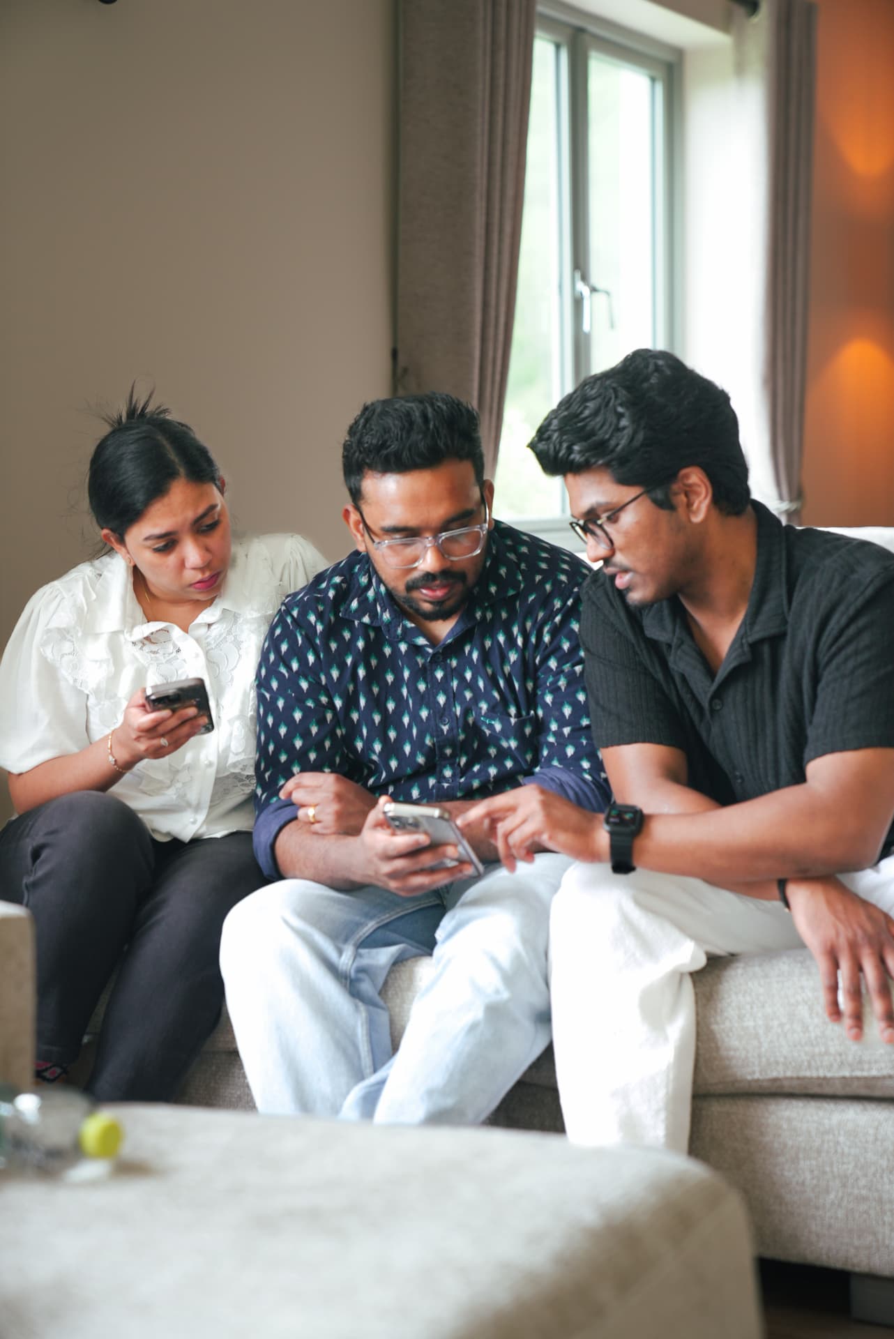 Three members working through something together on their phones