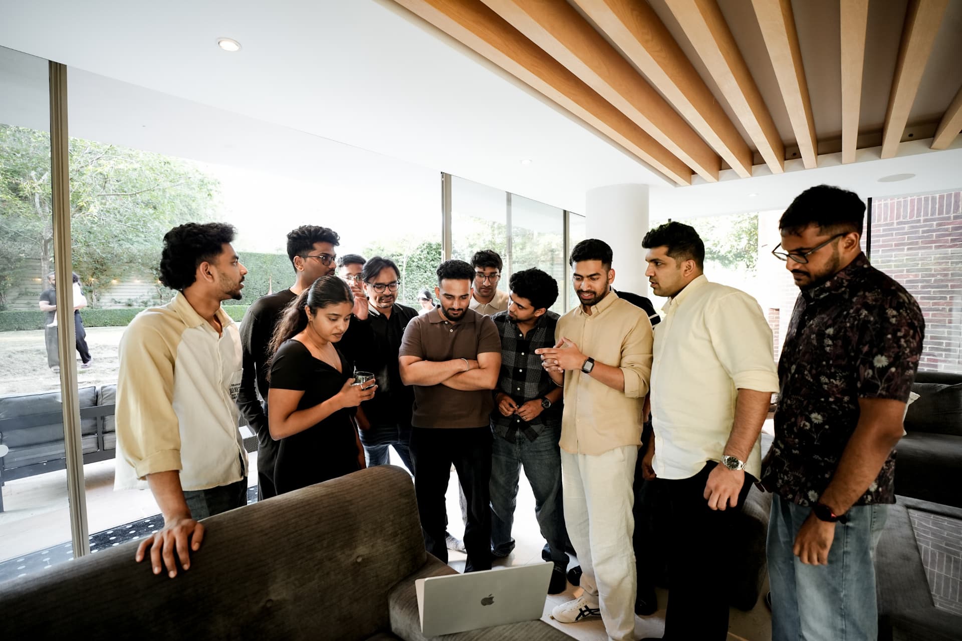 Members gathered around a laptop at a meetup