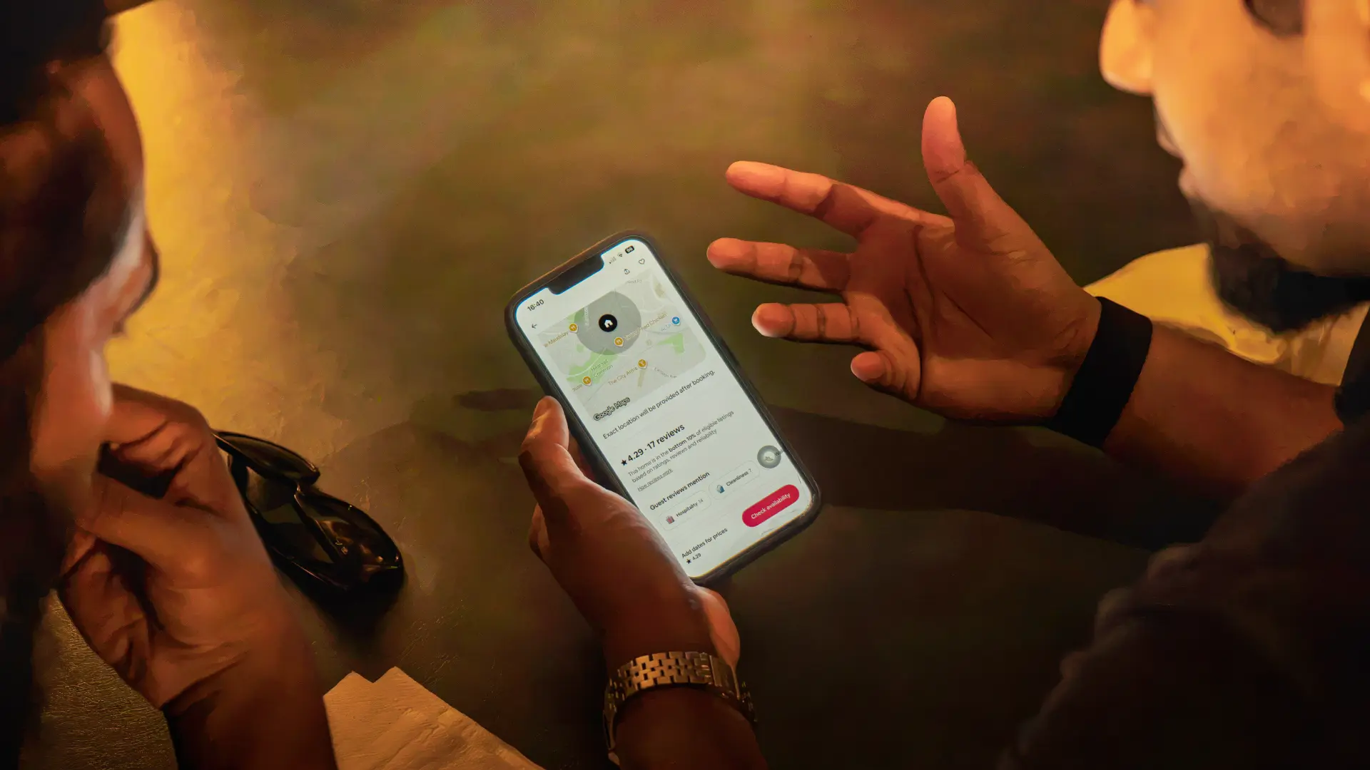 Members looking through a property listing on a phone at a meetup