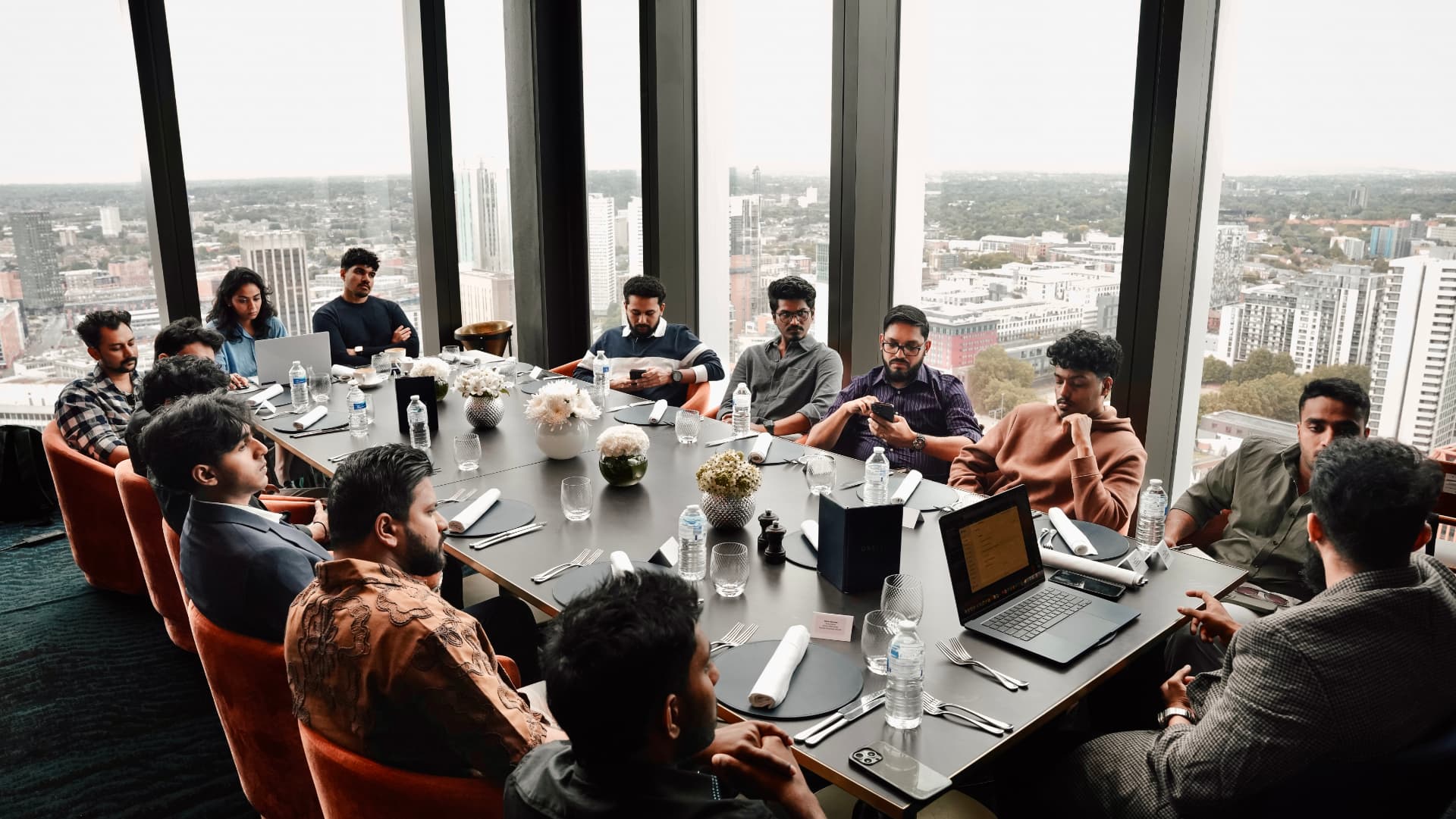 The group gathered around a long table high above the city