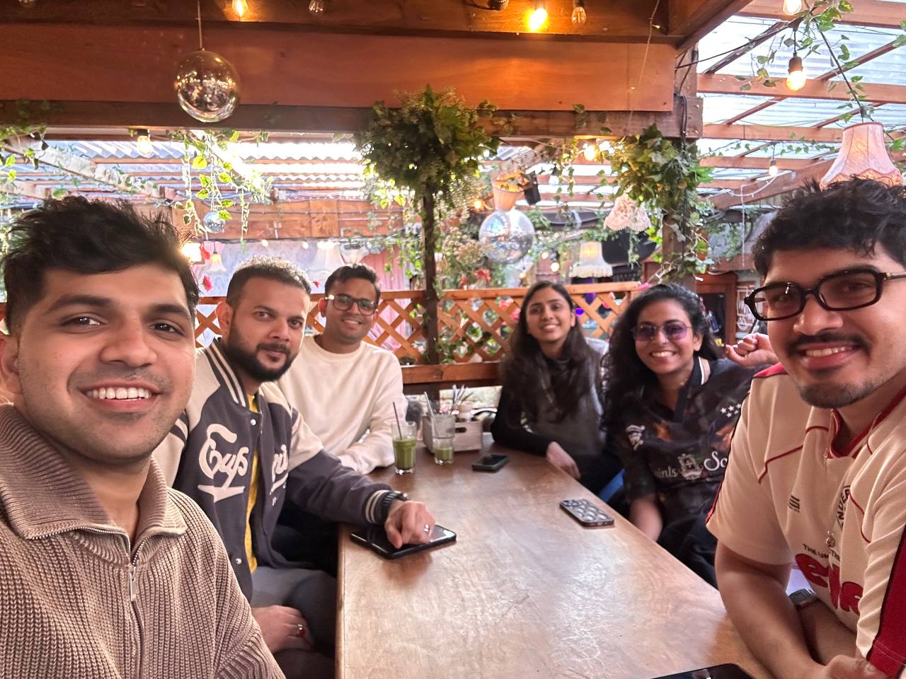 Members sharing a table at a rooftop meetup