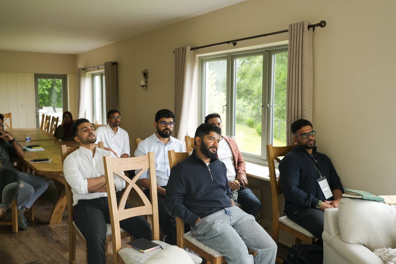 Members working around a laptop at a meetup