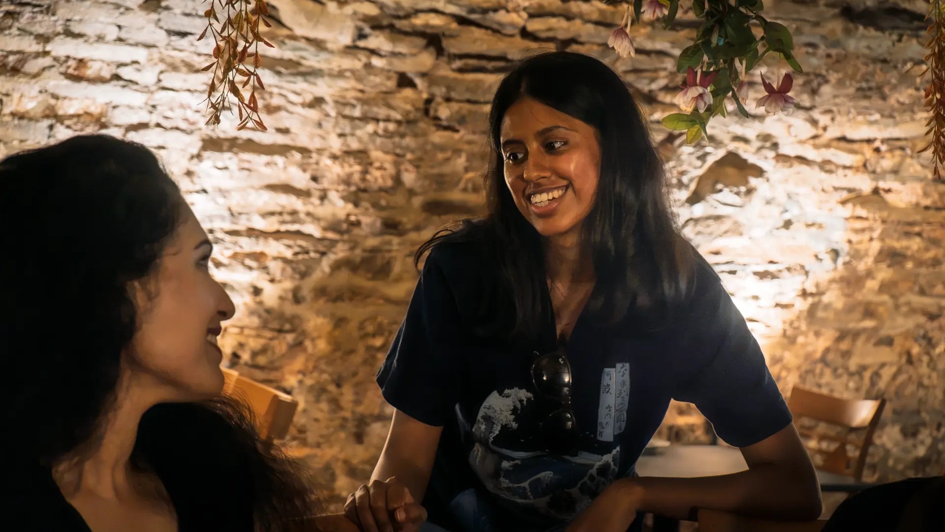 Two members in conversation at a meetup dinner