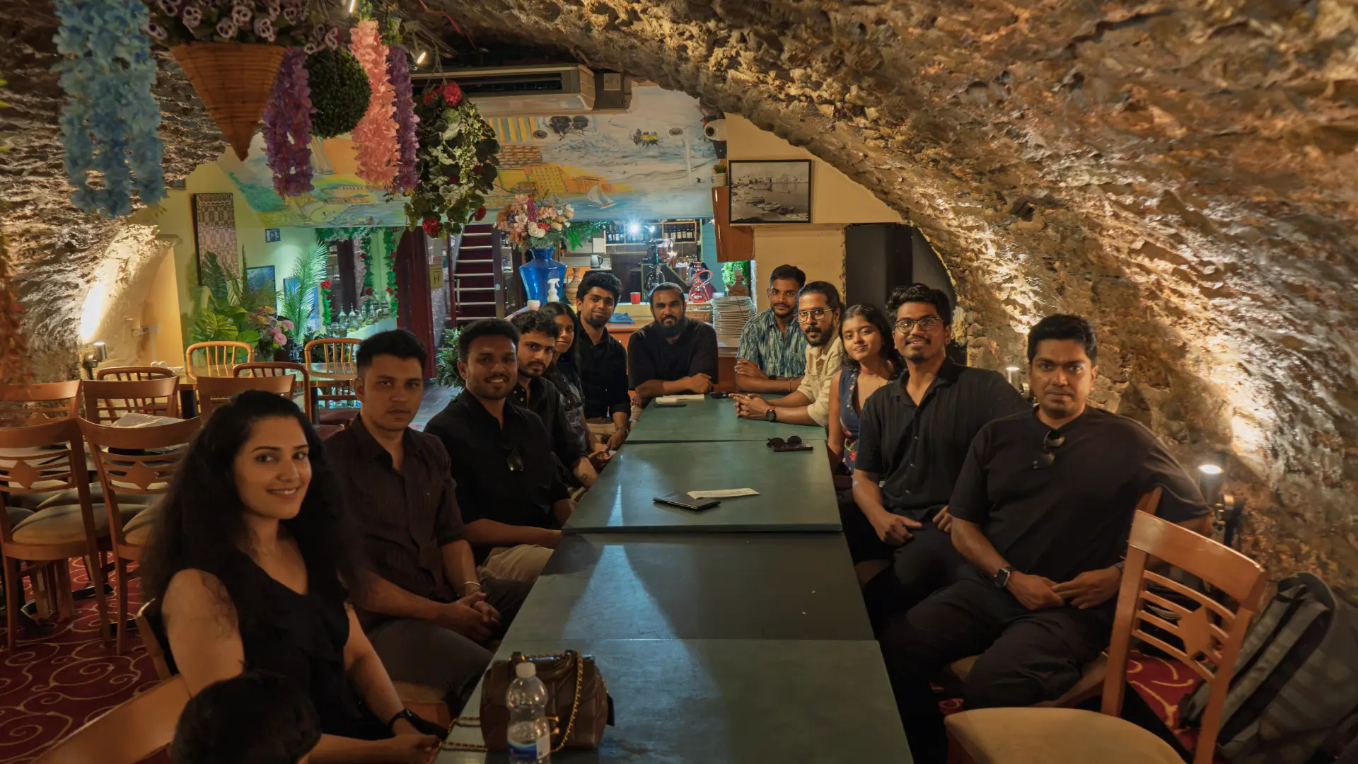 The community around one long table at a meetup dinner
