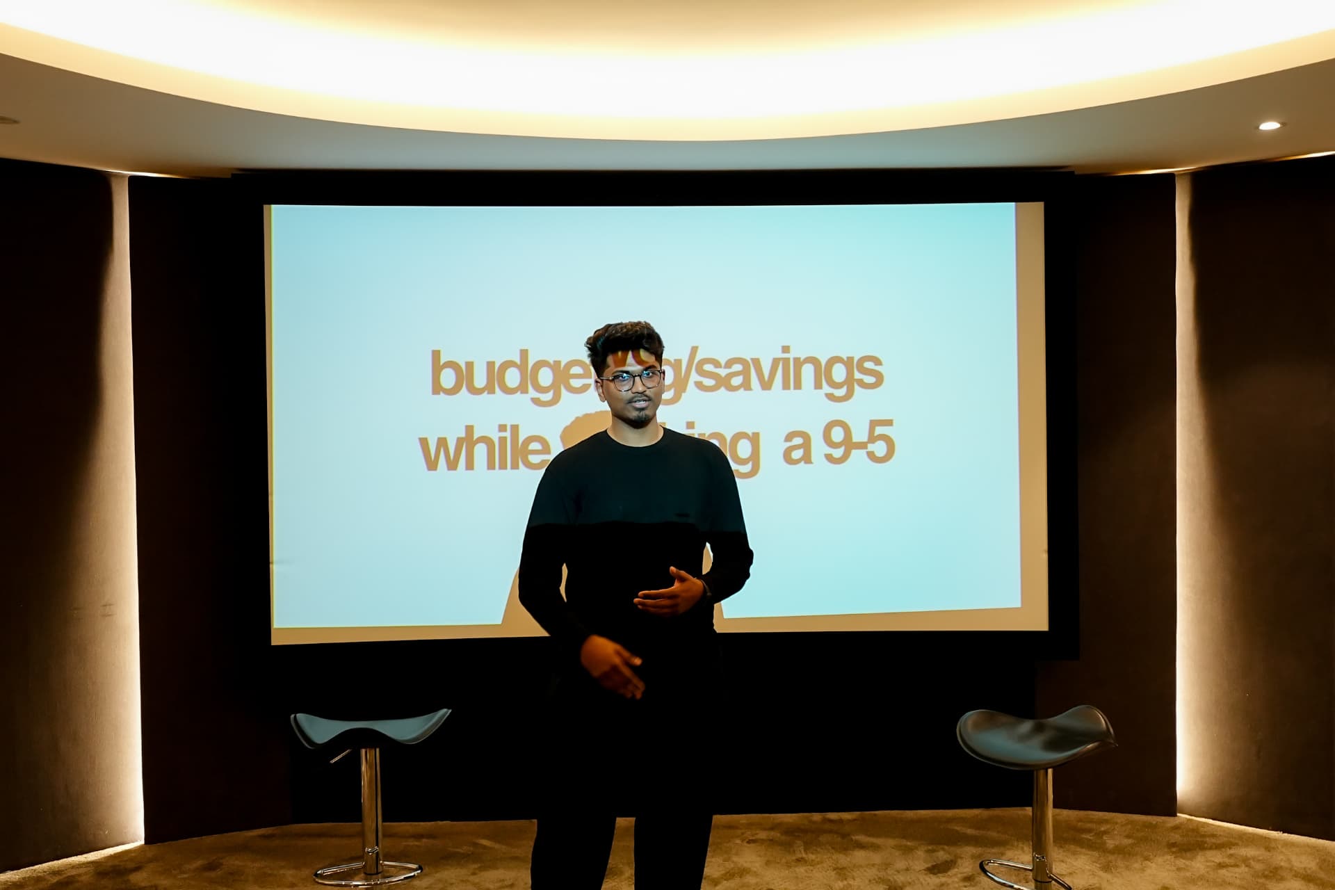 A member presenting in front of a slide at a meetup