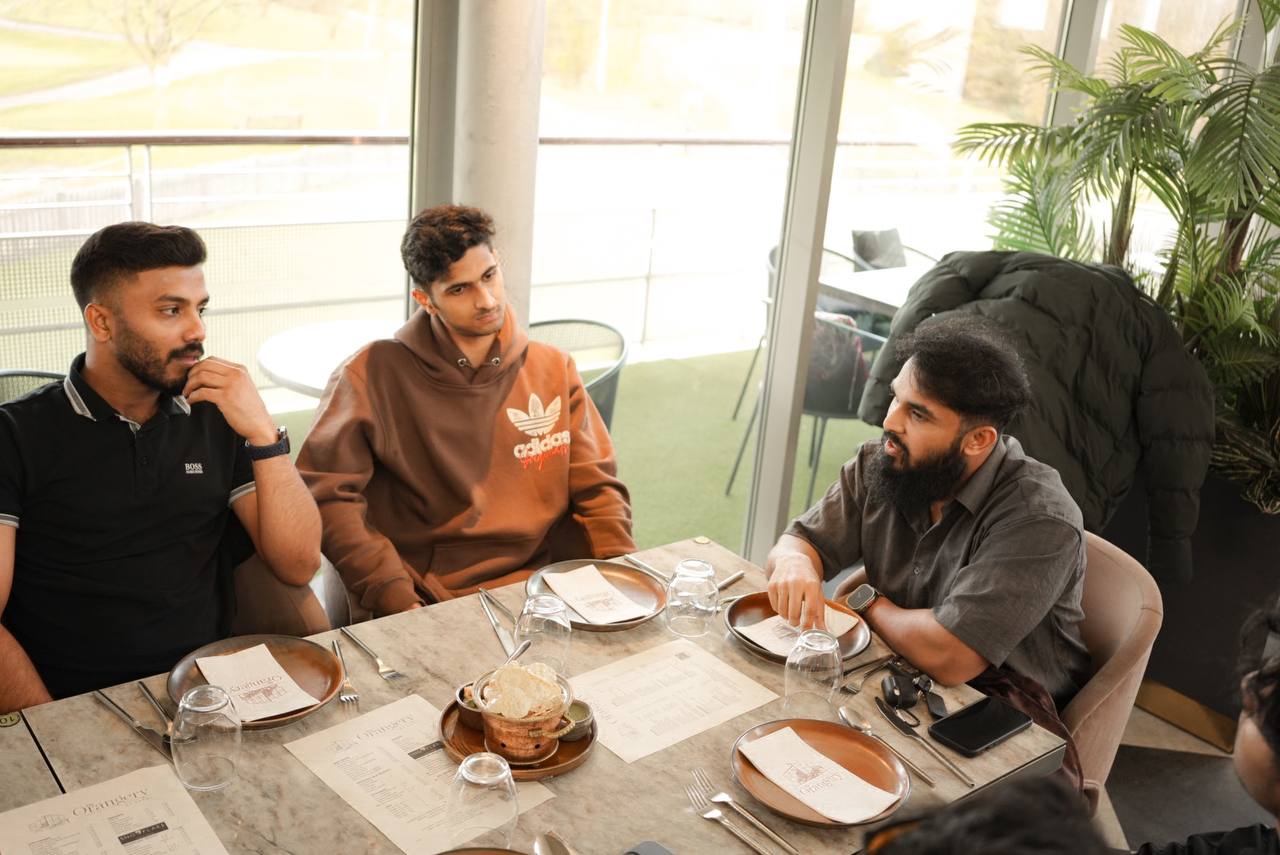 Members discussing deals at a meetup table