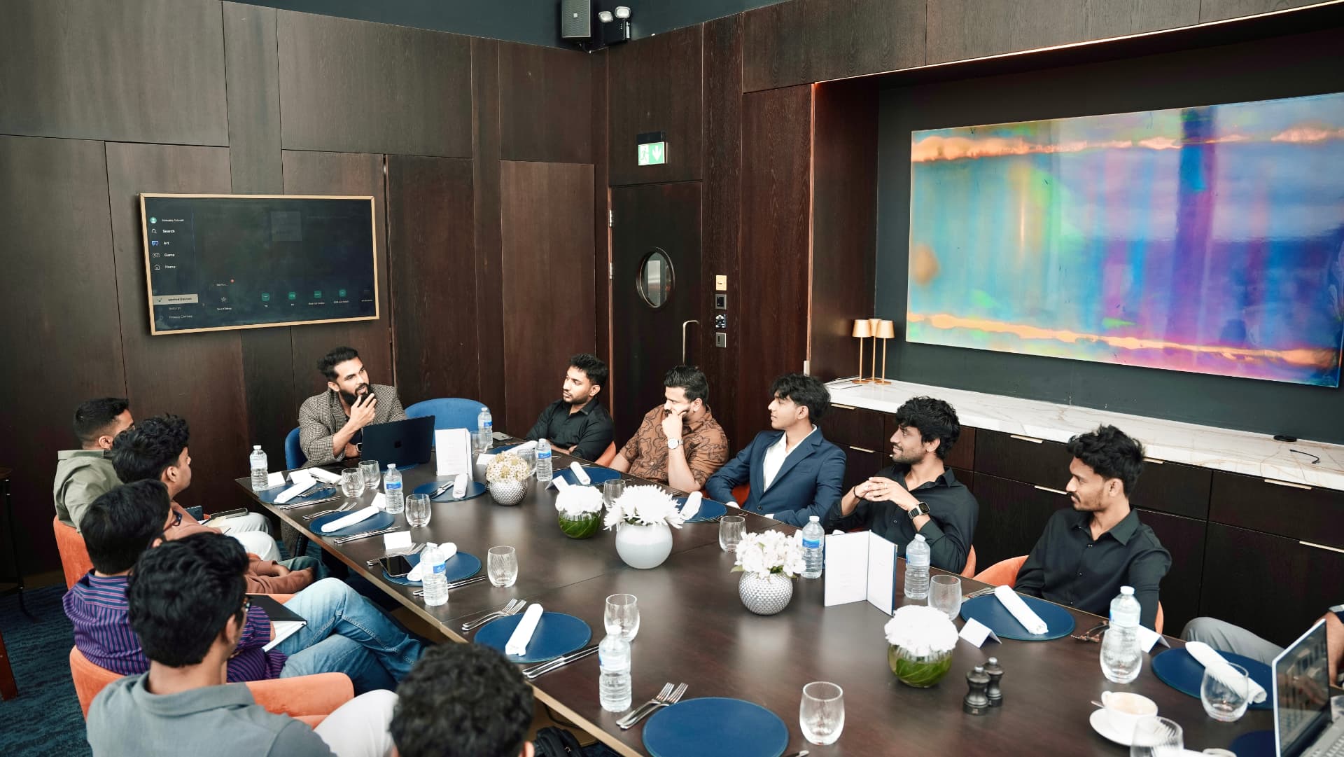 Members in discussion around the boardroom table at a meetup