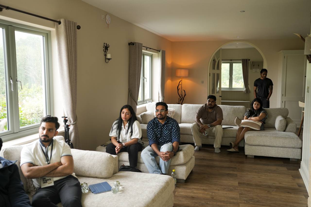 Members watching a session from the sofas at a stayover